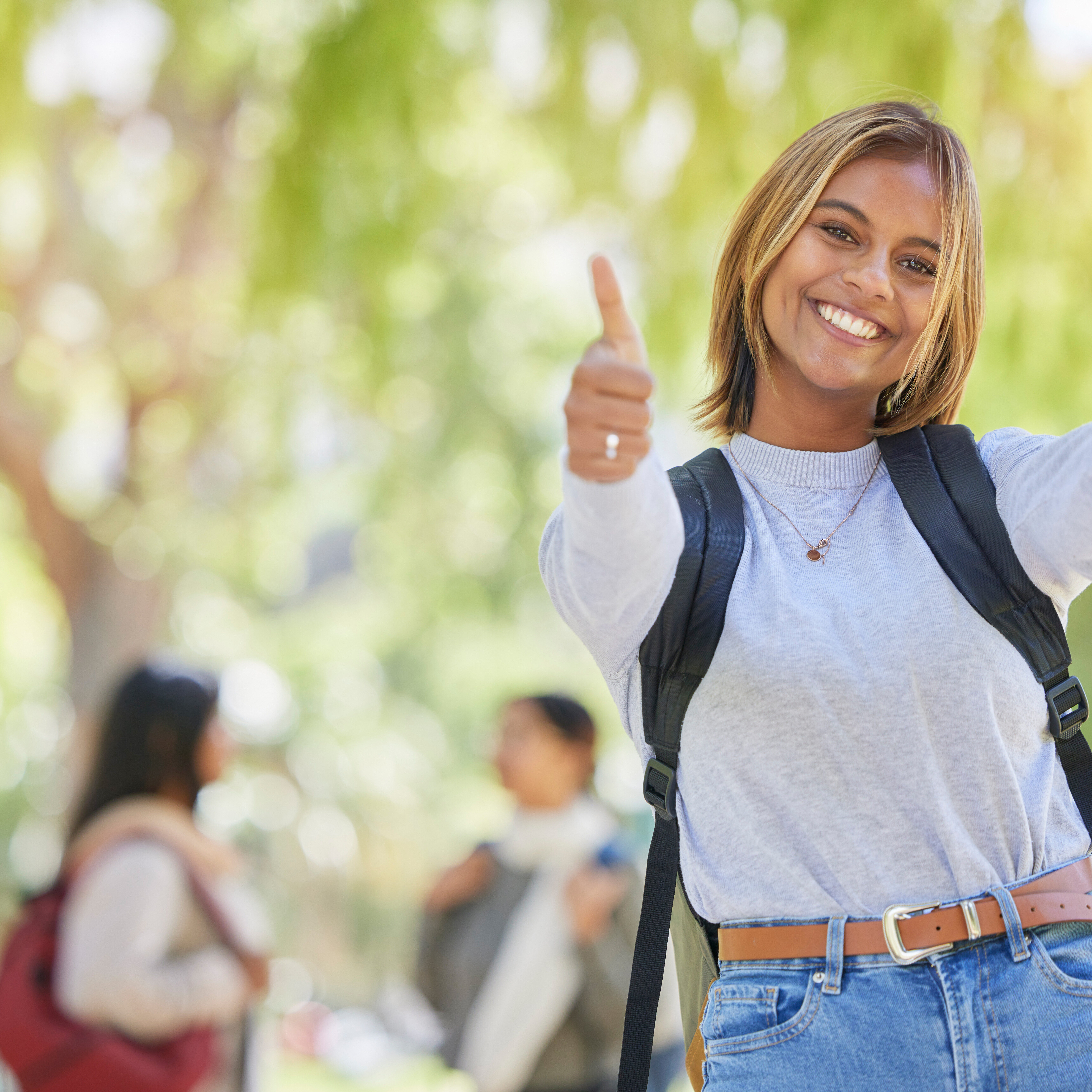 Young woman, thumbs up and university student, yes and success in education, academic study and to learn mockup. Agreement, smile and scholarship with degree, learning and portrait on New York campus.